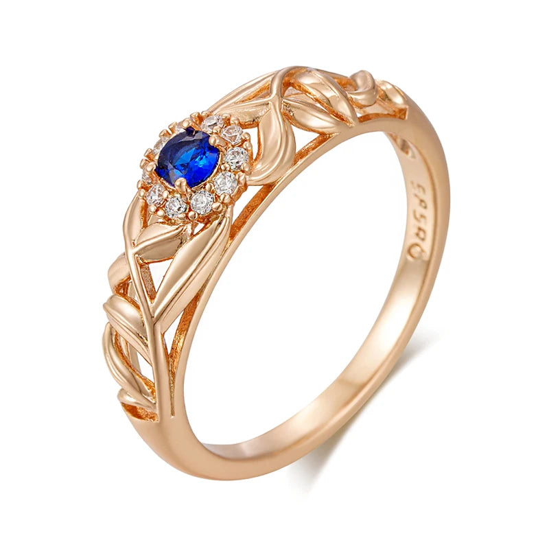 Anel Encantado com Design Vazado de Folhas e Zircônia Azul Central, Acabamento em Ouro Rosé 14K